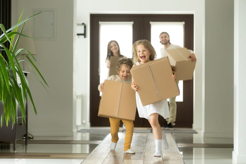 Family happily running into their new home